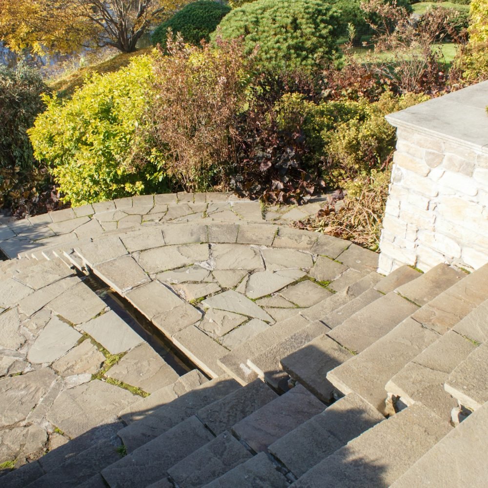 Cottage garden with stone stairs and retaining wall